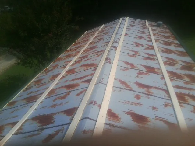 Rusted metal roof panels with new wood purlins before replacement — Storm Damage Roof Repair in Bridgeview by Roofing Brothers