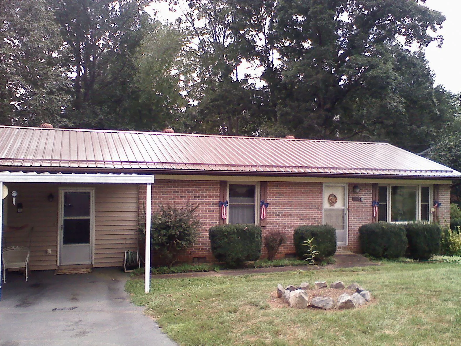 Bronze metal roof and carport on a brick ranch home — Roof Repair work by our crew in Bridgeview